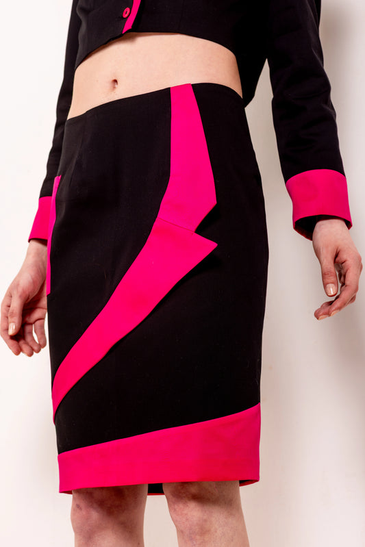 Jupe crayon noire au-dessus du genou avec bande diagonale rose fuchsia